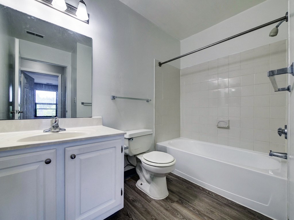an empty bathroom with a sink toilet and tub