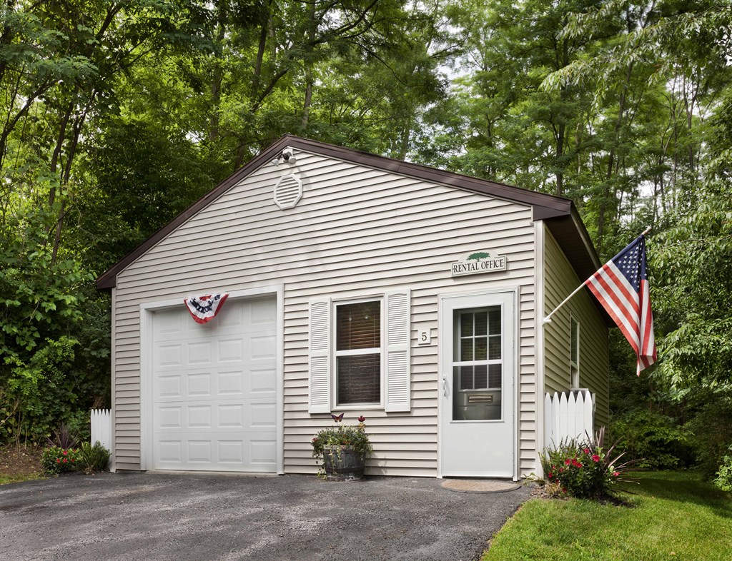a small white building with an flag on the side of it