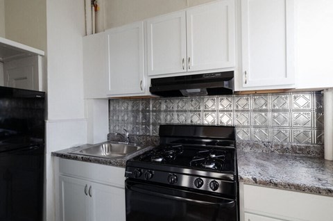 a kitchen with a stove and a sink