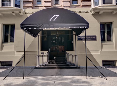 a black awning in front of a building with stairs