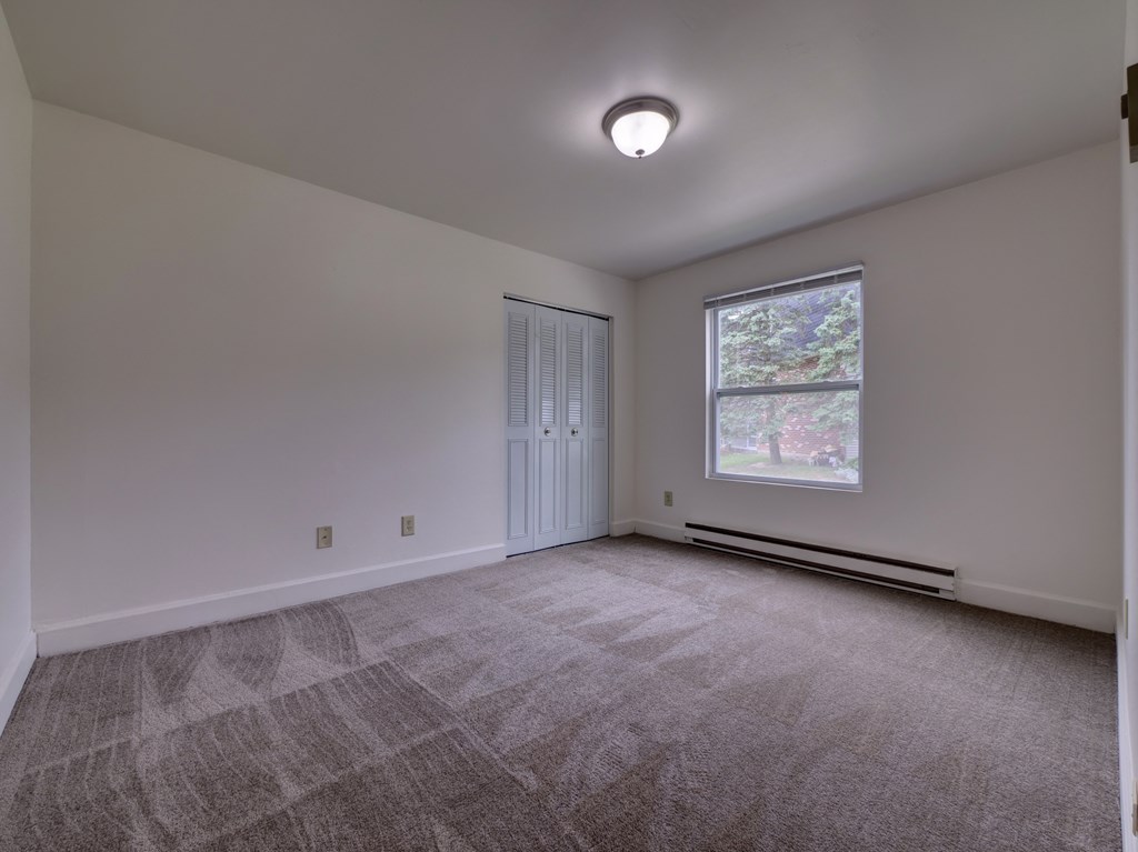 Bedroom with accessible closet and window at Cedar Park Apartments, Troy, NY, 12180