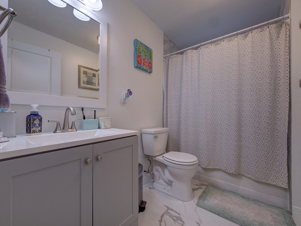 Bathroom with a toilet and a sink at Cedar Park Apartments, Troy, New York
