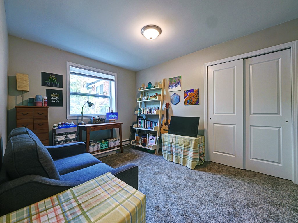 Living room with a couch and a tv at Cedar Park Apartments, Troy, NY, 12180