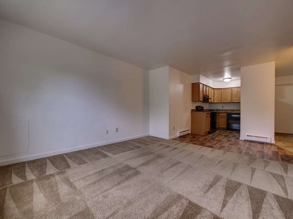 Living room and kitchen with carpeting at Cedar Park Apartments, Troy, NY, 12180