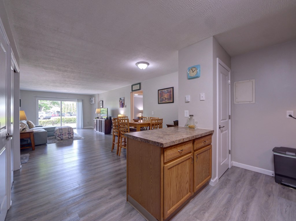 Kitchen island and a living room with a dining room at Cedar Park Apartments, Troy, NY