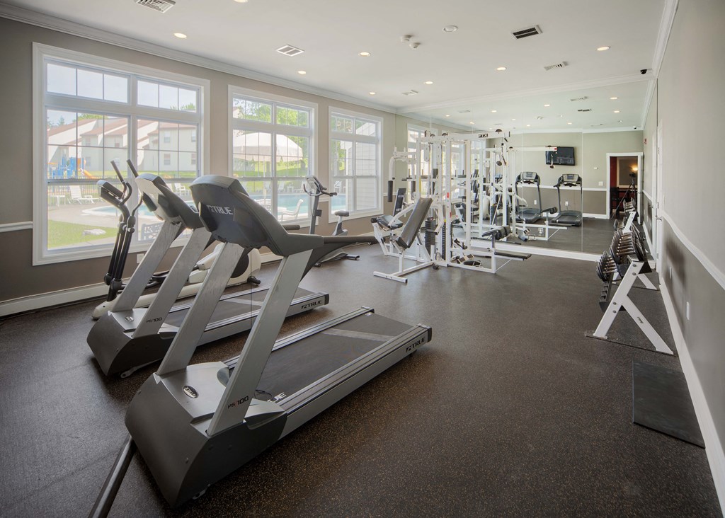 a gym with treadmills and other exercise equipment