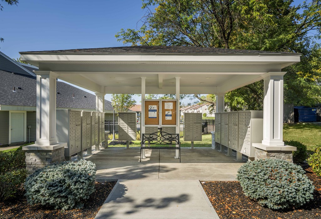 a covered patio with a table and chairs under a pavilion