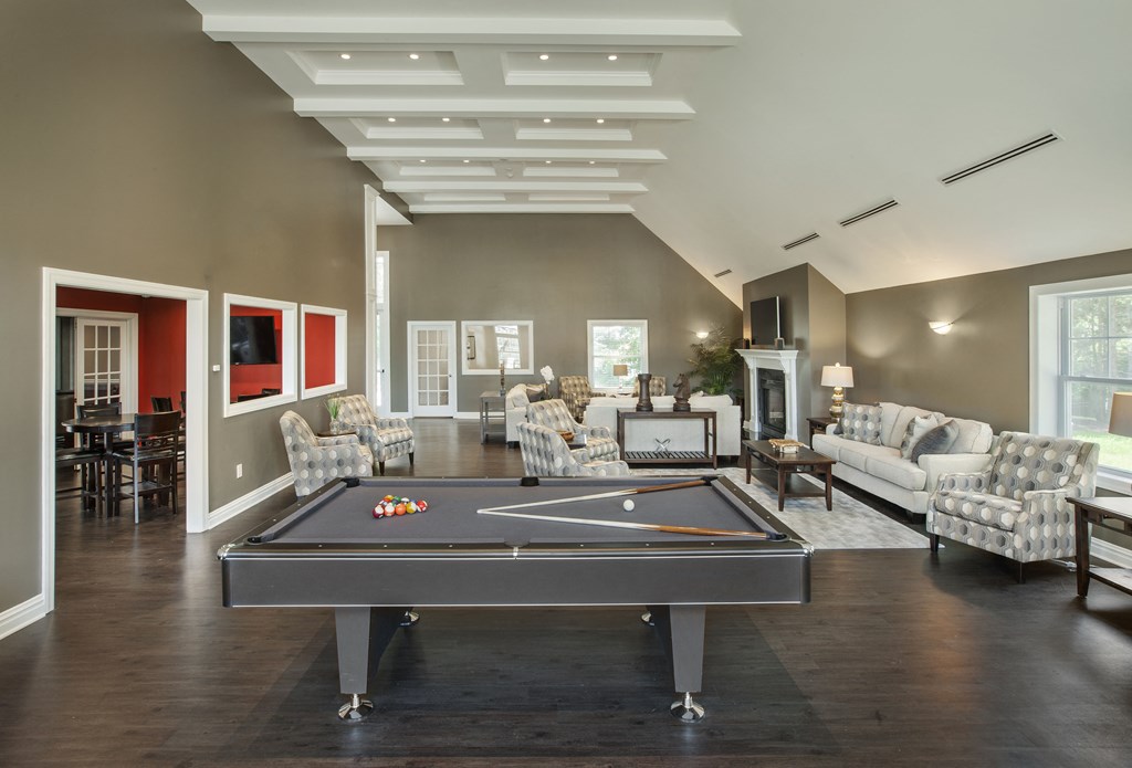 a living room with a pool table in the middle