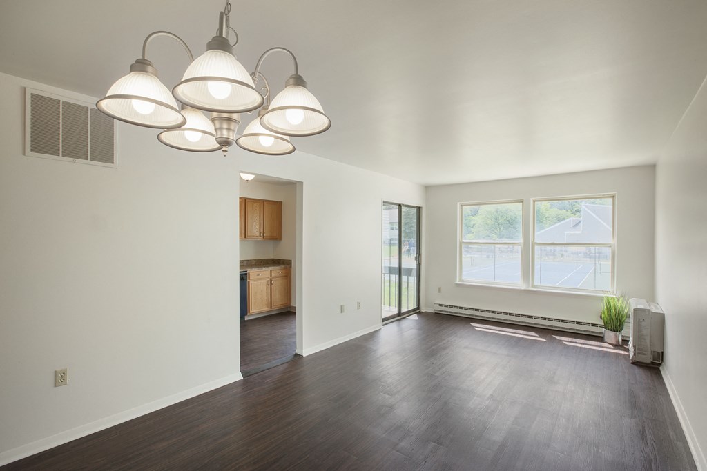 the living room of an empty house with a large window