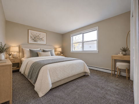A bedroom with a bed, nightstand, and chair.