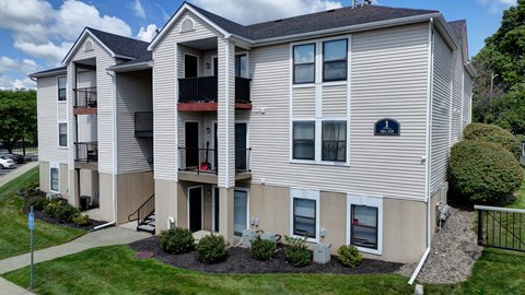 A large apartment building with a balcony on the second floor.
