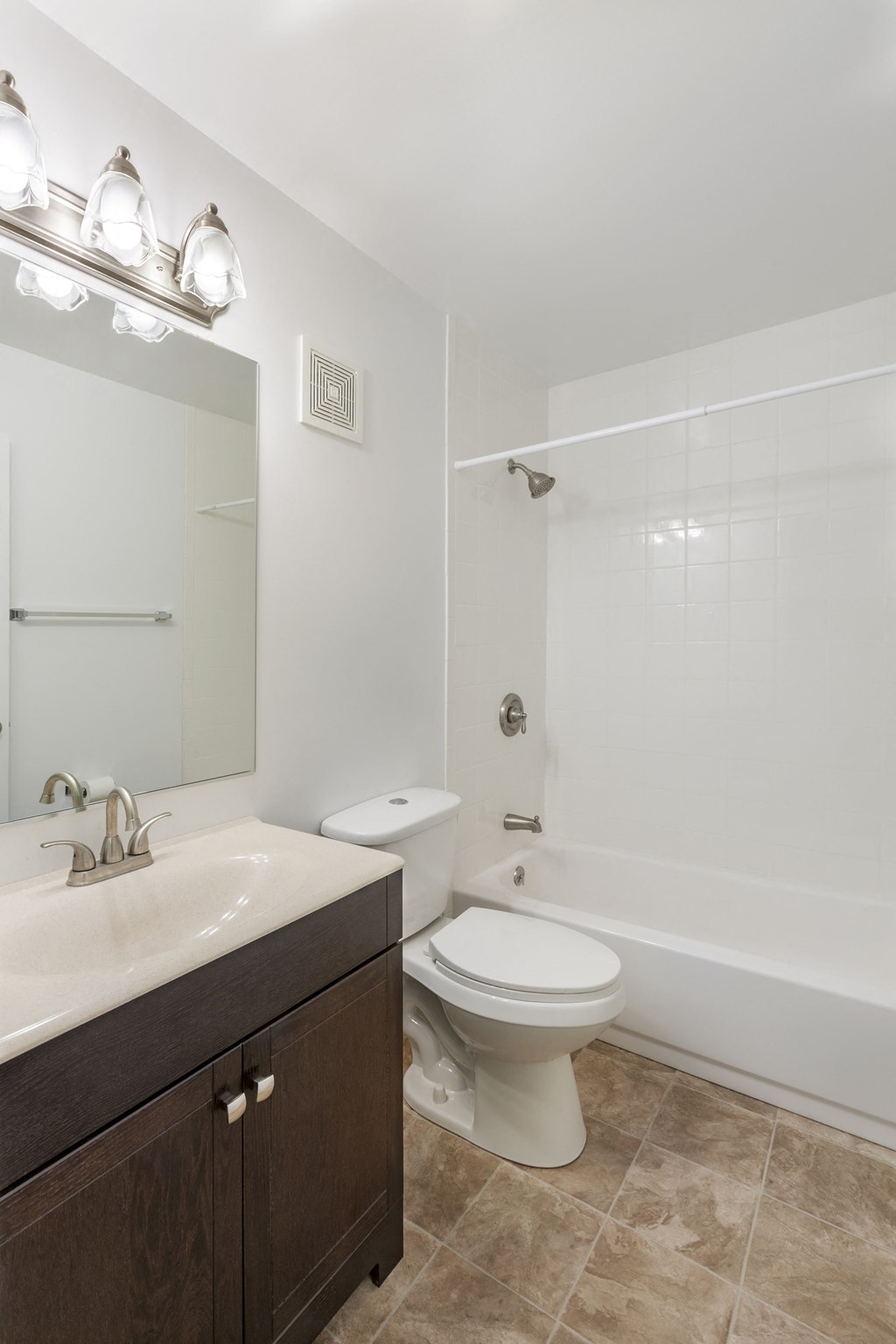 a bathroom with a toilet and a sink and a shower