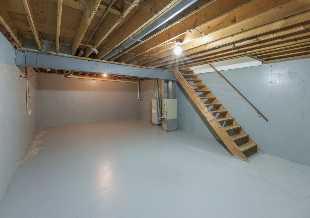 a unfinished basement with a staircase in it