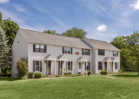 a white house with a lawn in front of it