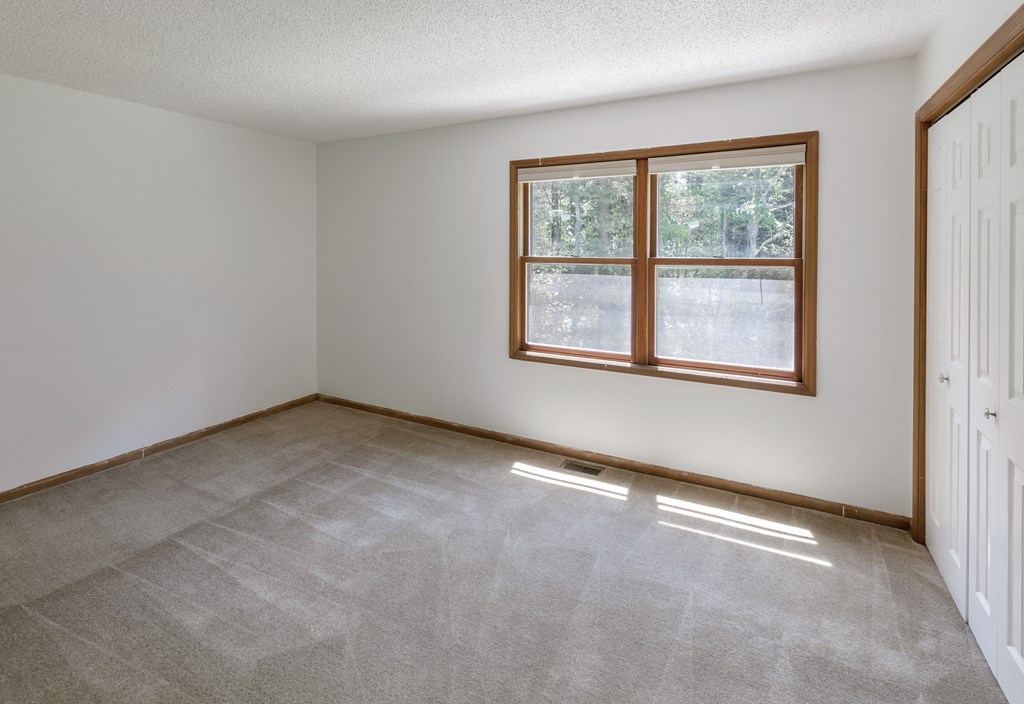 the living room of an empty house with a window