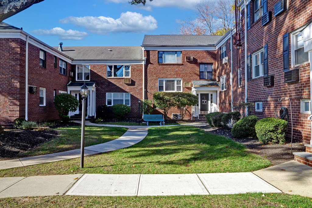 A brick building with a white door and windows.