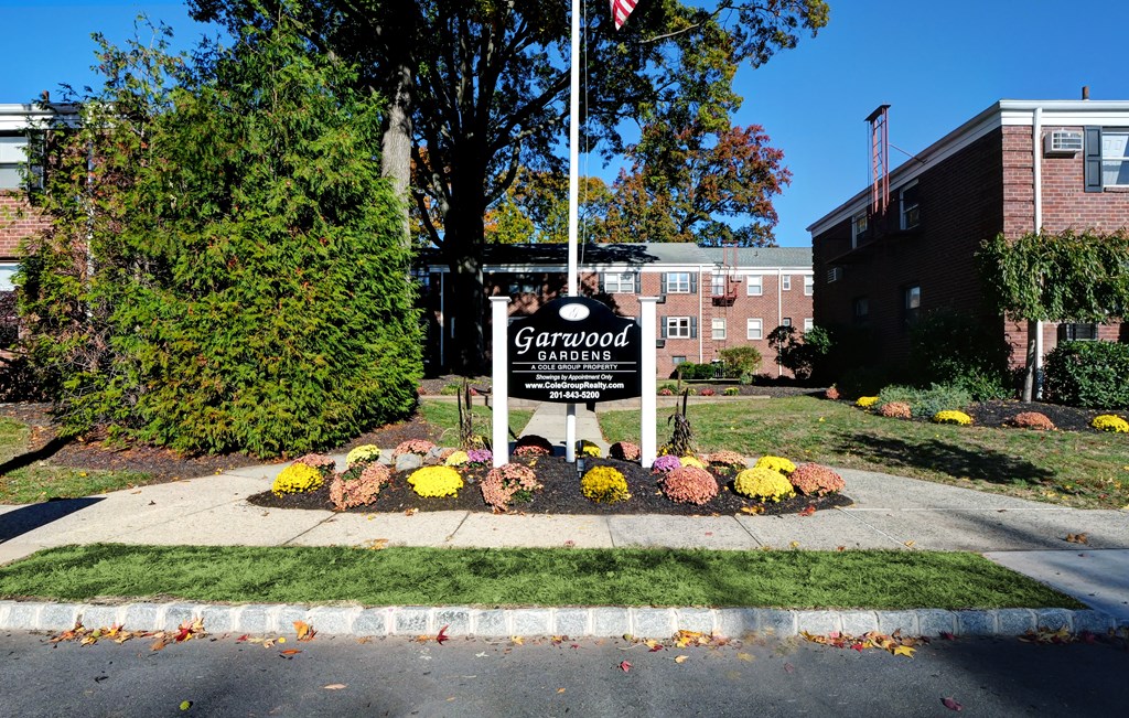 A sign for Garden Grove Elementary School is in front of a building.