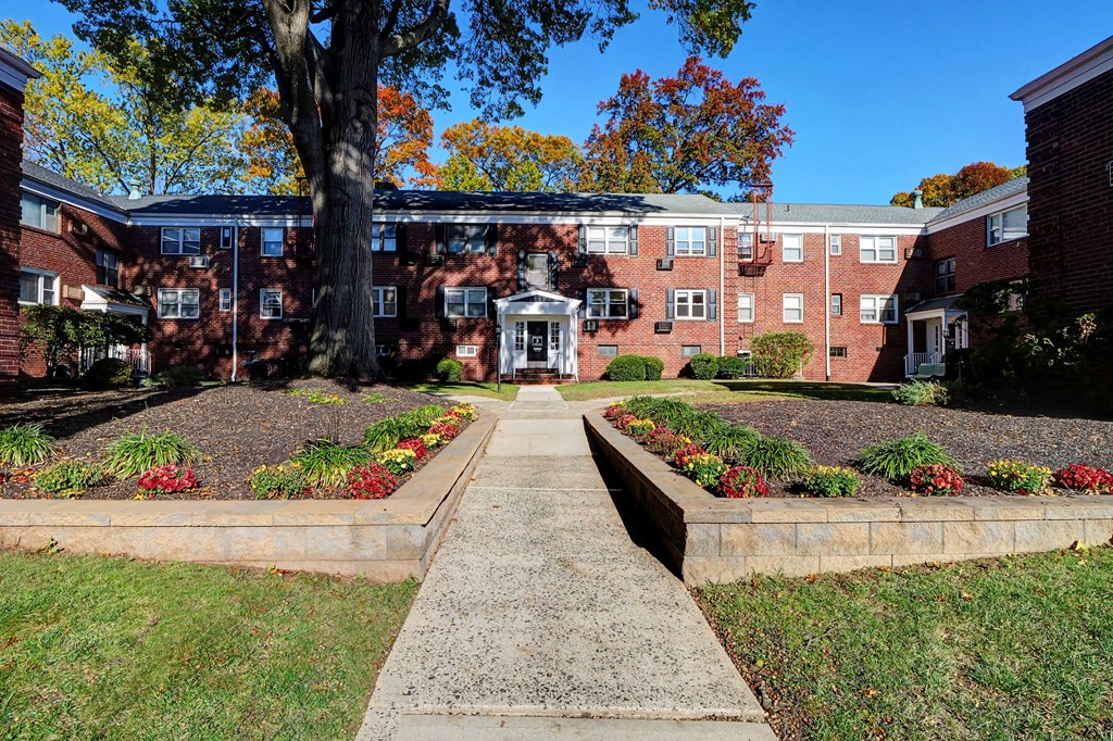 A brick building with a tree in front of it.
