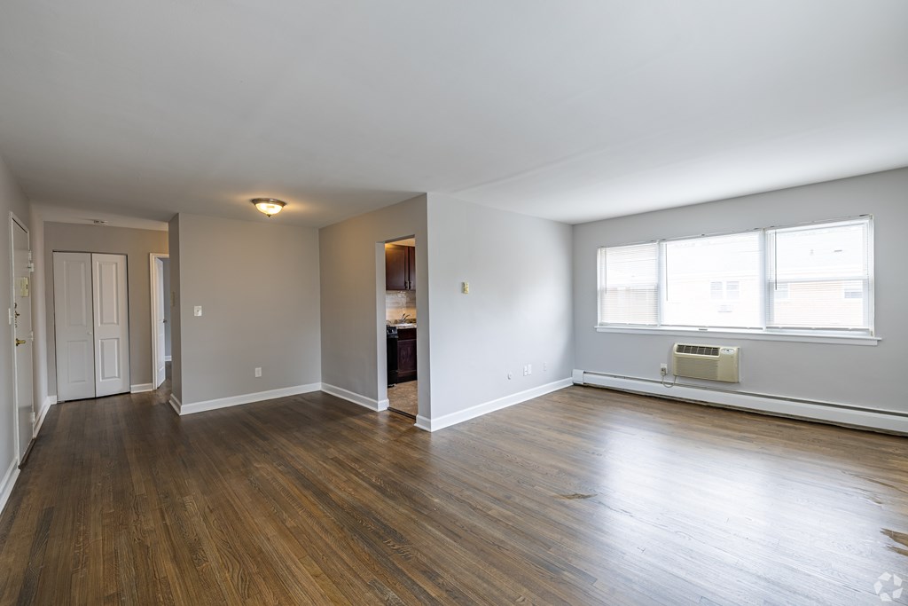 A room with wooden floors and a window.