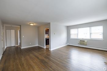 A room with wooden floors and a window.