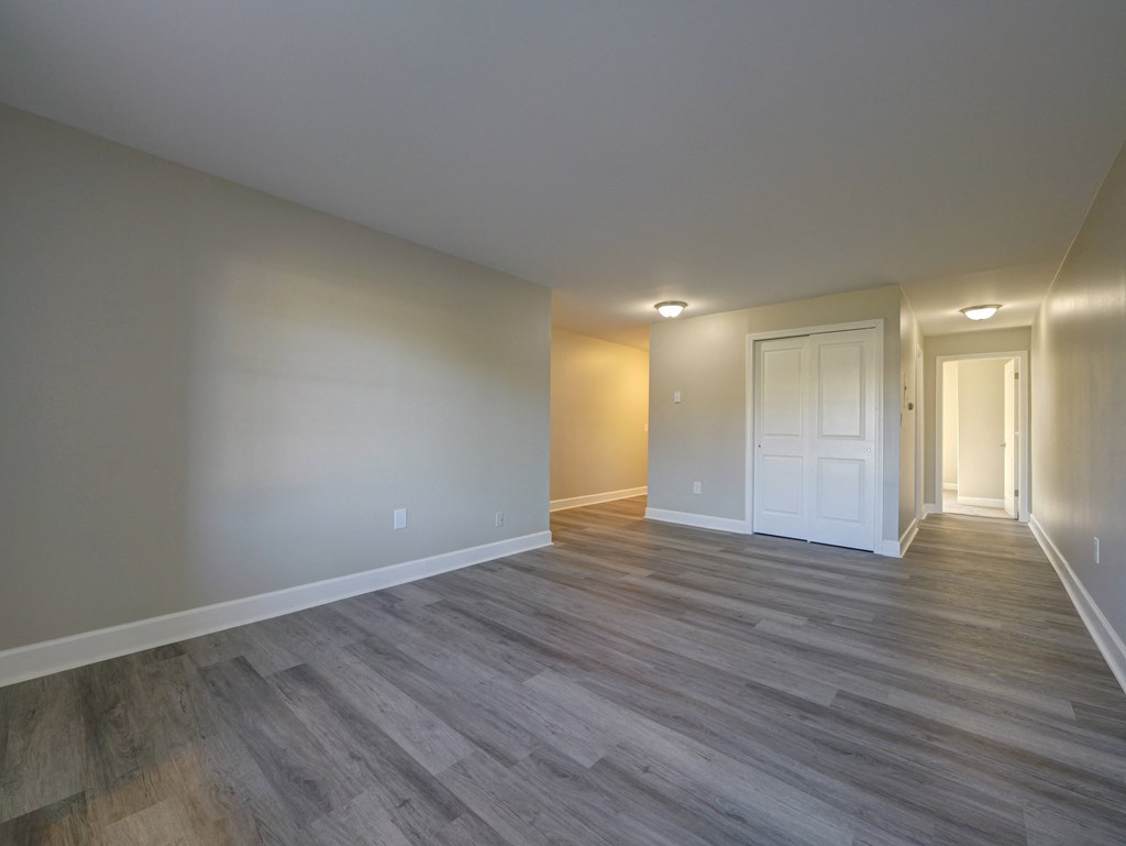 A room with a wooden floor and white walls.