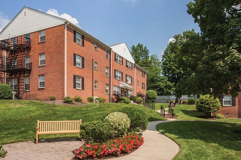 a brick building with a sidewalk in front of it