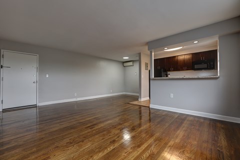 A room with wooden floors and a white door.