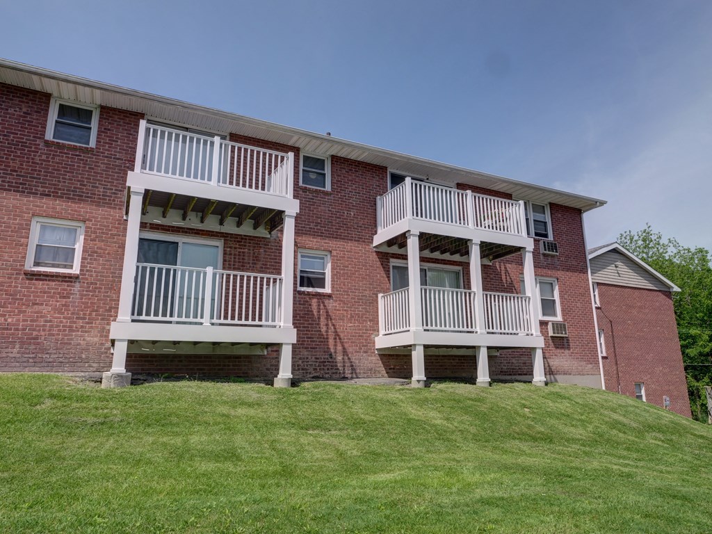 a brick apartment building with two sets of balconies