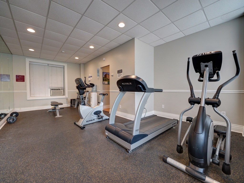 A gym with a treadmill, elliptical trainer and a stationary bike. at Willett Apartments, Albany, NY, 12210