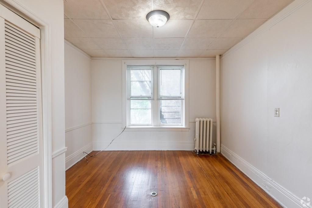 A room with a window and a radiator on the floor. at Willett Apartments, Albany, NY, 12210