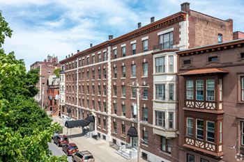 A street view of a city with cars and buildings.