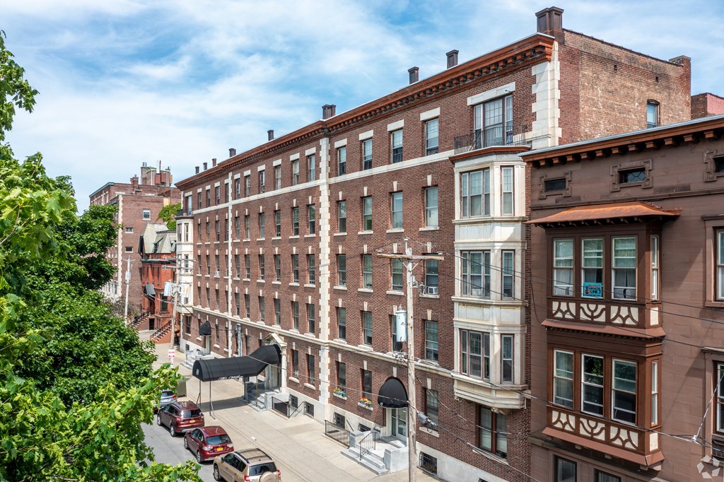 A street view of a city with cars and buildings.