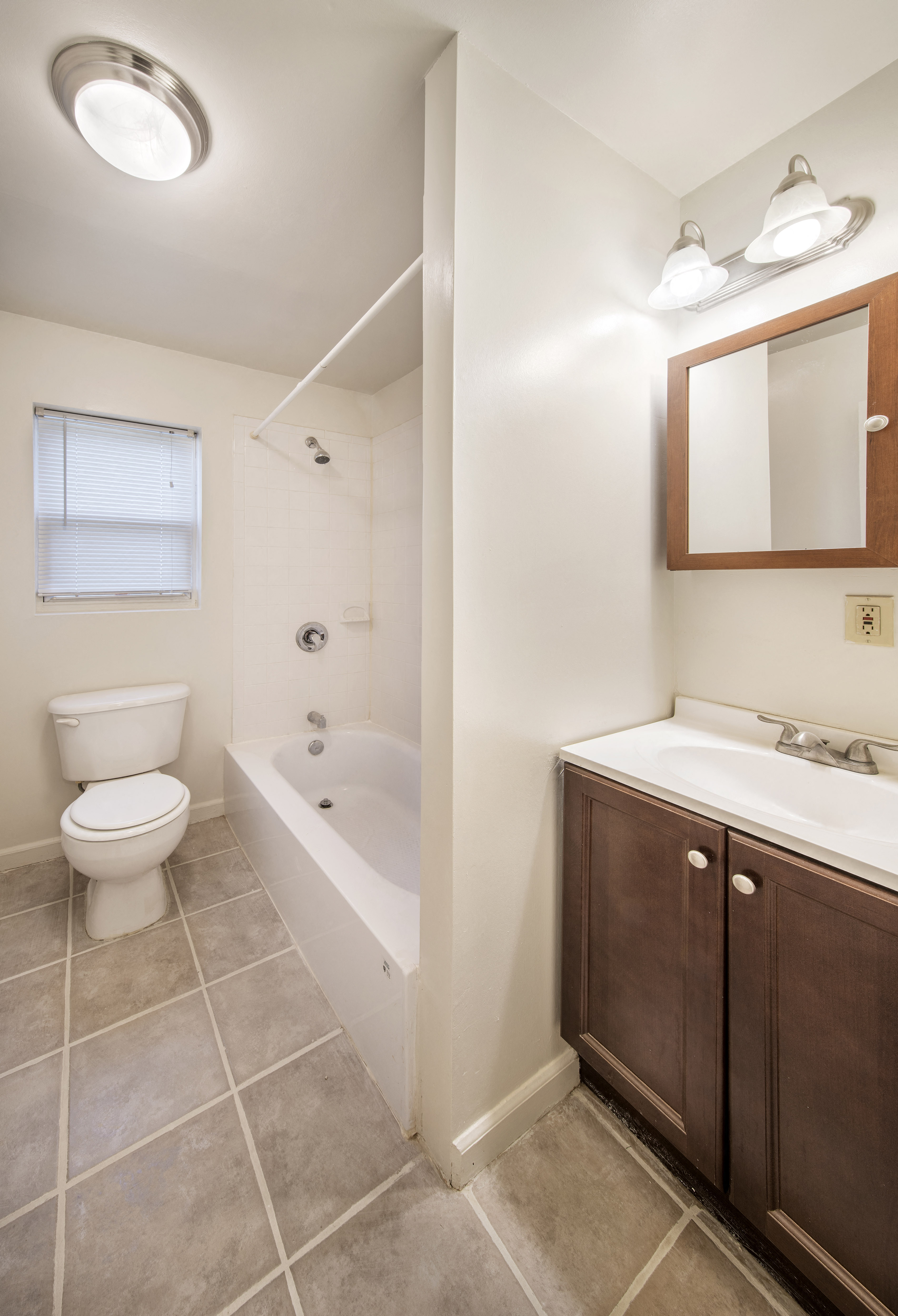 a bathroom with a toilet and a sink and a bath tub