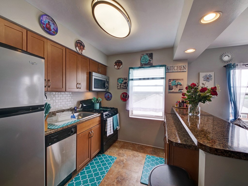 a kitchen with stainless steel appliances and a granite counter top