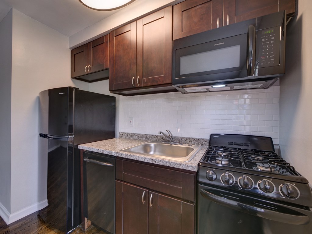 a kitchen with a sink and a stove and a refrigerator
