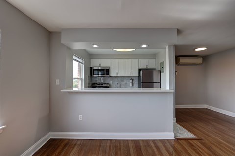 A kitchen area with a microwave, oven, and refrigerator.