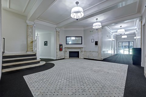 A large, empty room with a fireplace and a television.