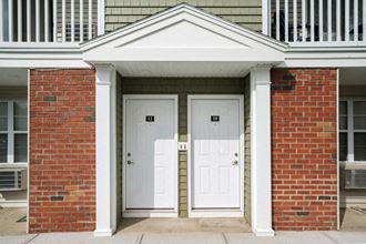 a pair of white doors on a red brick building