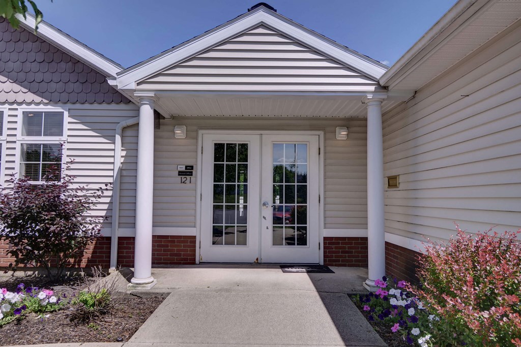 a house with a white door and a walkway in front of it
