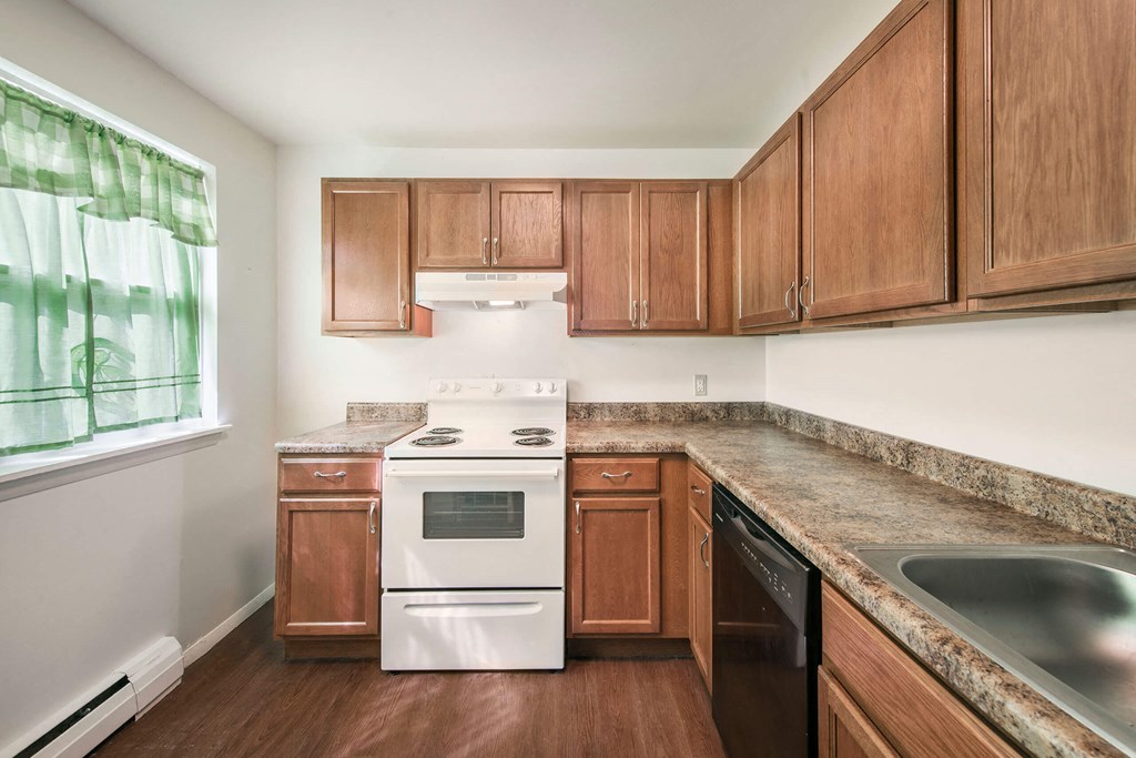 a kitchen with wood cabinets and white appliances