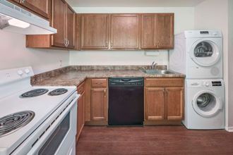 a kitchen with wood cabinets and white appliances