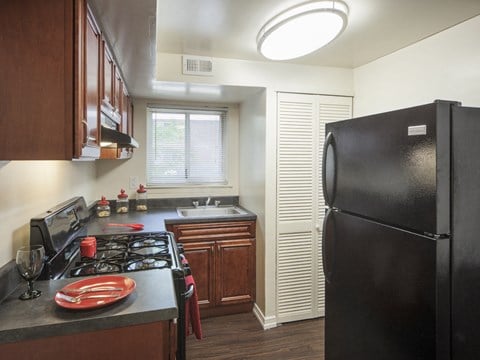 a kitchen with black appliances and a black refrigerator