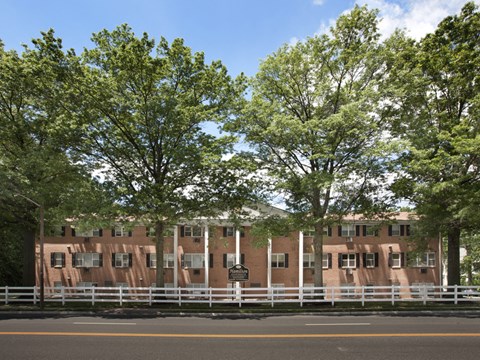 A building with a white fence in front of it.