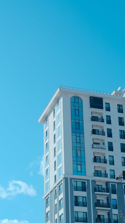 A tall building with blue sky in the background.