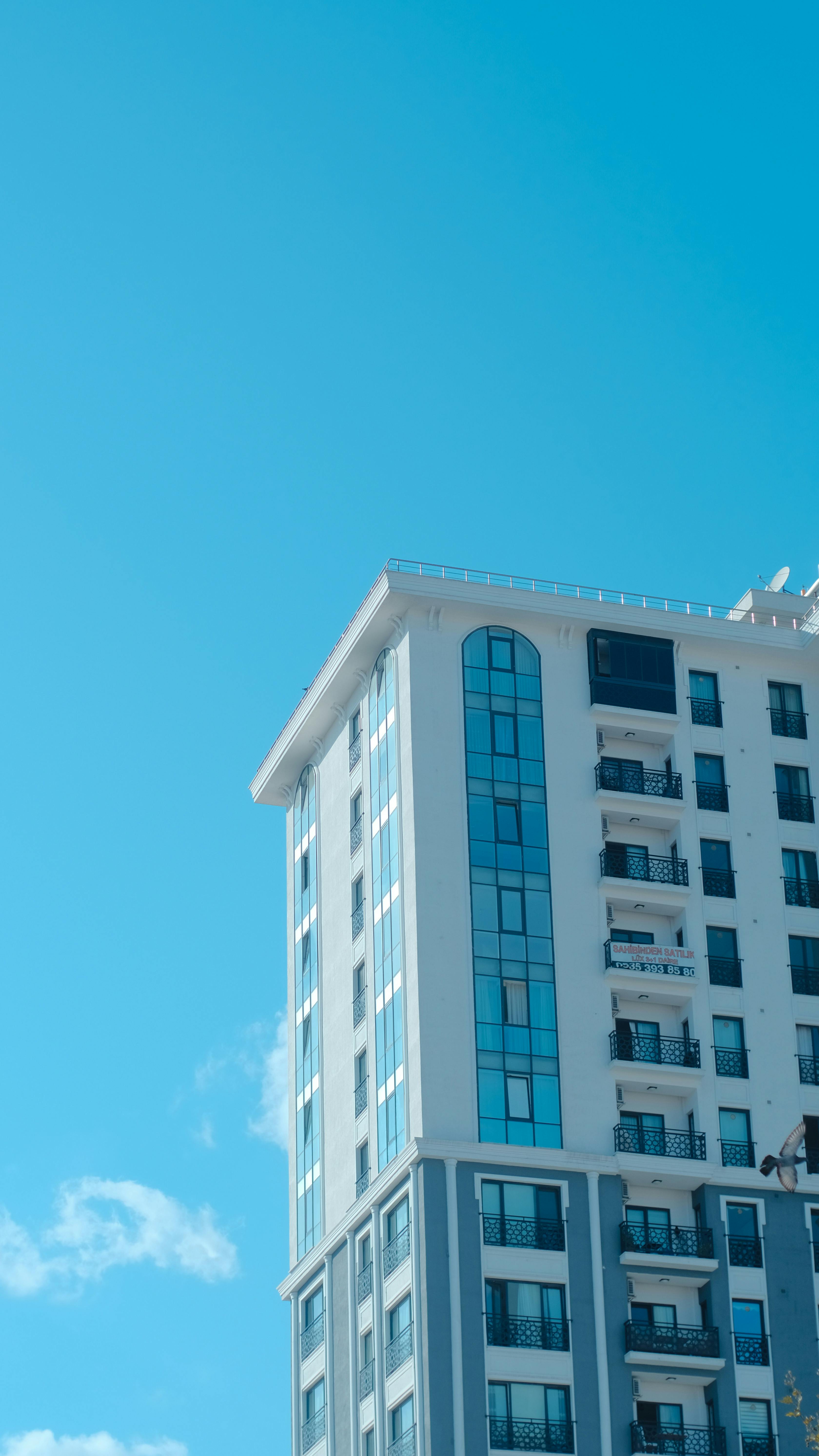 A tall building with blue sky in the background.