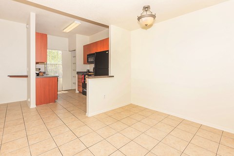 A kitchen area with a refrigerator, microwave, and oven.