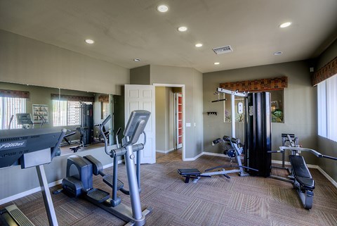 A spacious home gym with a variety of exercise equipment.