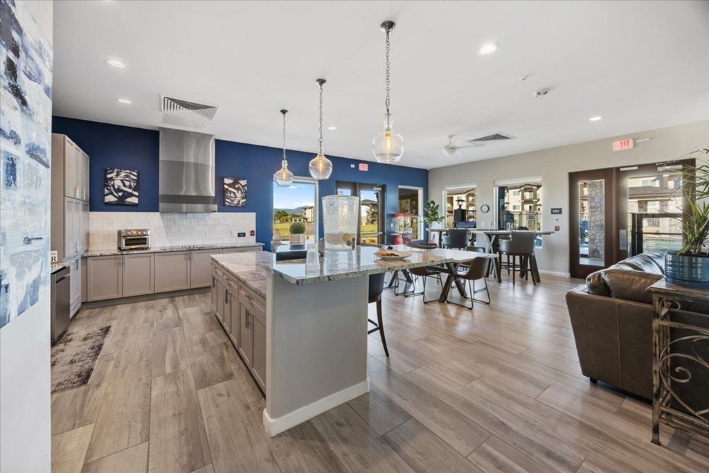 a kitchen with a center island and a dining table