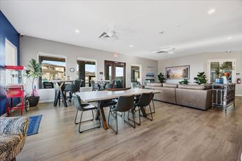 a living room and dining room with a table and chairs