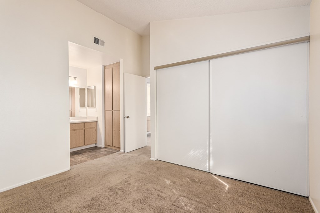 A room with a carpeted floor and white walls.